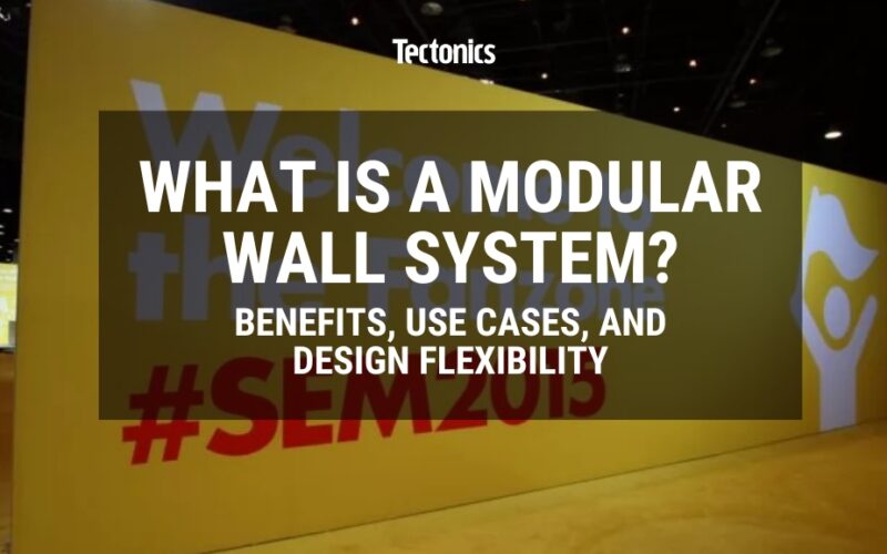 large yellow modular wall at a tradeshow with the the text "what is a modular wall system" on top of it